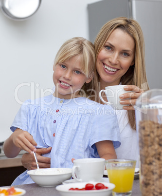 Mother and daughter having breakfast together