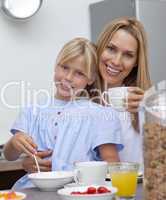 Mother and daughter having breakfast together