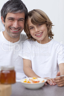 Portrait of dad and son having breakfast together