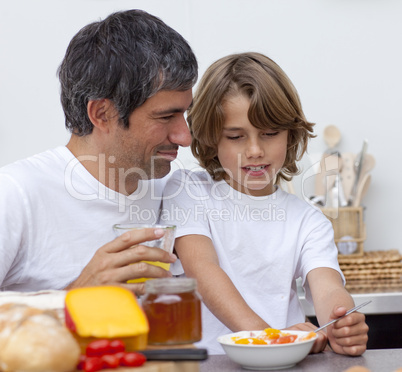 Portrait of father and son having breakfast together