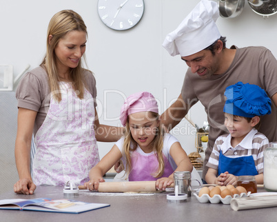 Parents helping children baking in the kitchen