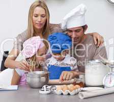 Children baking cookies with their parents