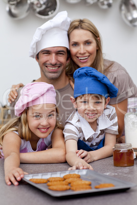 Happy children and parents eating biscuits