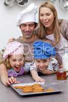 Children and parents eating cookies after baking