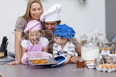 Happy family baking cookies in the kitchen