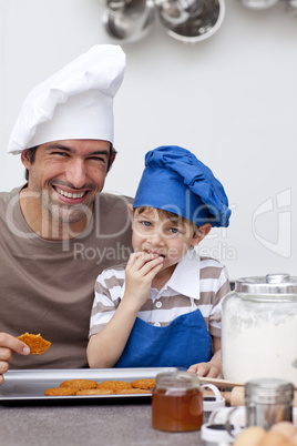Father and son eating home-made cookies