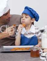 Father and son eating cookies