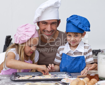 Father and daughter and son baking in the kitchen