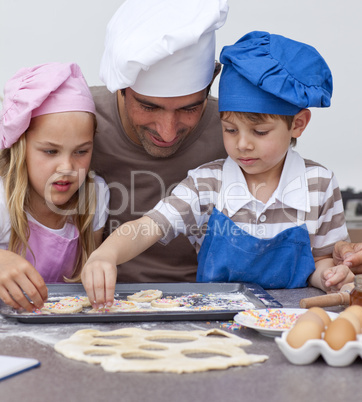 Portrait of father and children baking