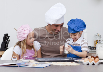 Father and children baking in the kitchen