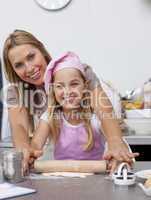 Mother and daughter baking Christmas cookies in the kitchen