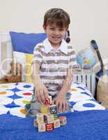 Little boy playing with alphabet cubes