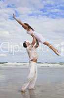 Yong Man and Woman Couple, Jumping in Celebration On Beach