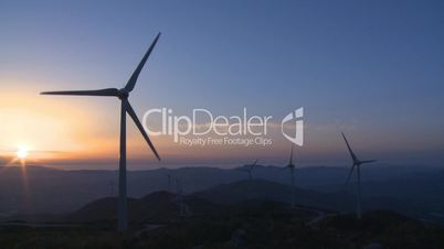 Wind turbine in the mountains at sunset