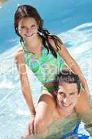 Father With Daughter On His Shoulders In Swimming Pool