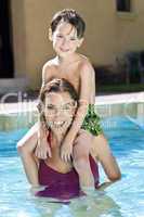 Mother With Son On Her Shoulders In Swimming Pool