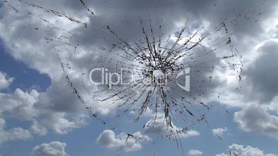 Cracked glass against sky time lapse