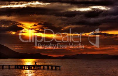 hdr sunset with dramatic clouds and pier