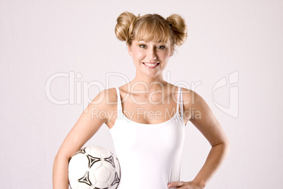 young blonde in sportswear with a football