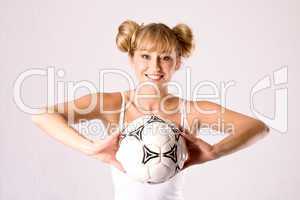 young blonde in sportswear with a football