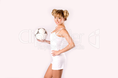 young blonde in sportswear with a football