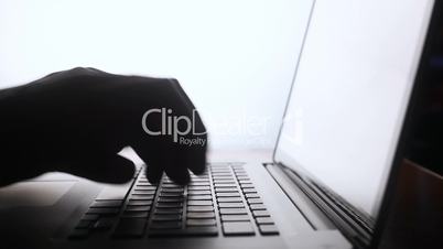 Typing on computer keyboard silhouette