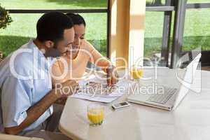 African American Couple Using Laptop Computer To Surf The Intern