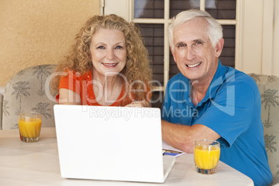 Senior Man and Woman Couple Outside Using Laptop Computer