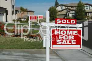 Sold Home For Sale Sign & New House