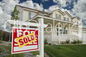 Sold Home For Sale Sign and House