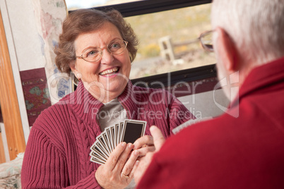 Happy Senior Adult Couple Playing Cards