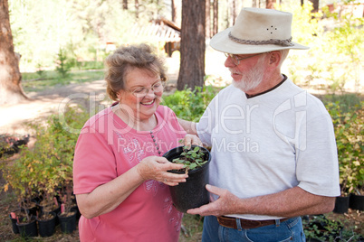 Attractive Senior Couple Overlooking Potted Plants