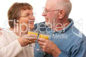 Happy Senior Couple with Glasses of Orange Juice