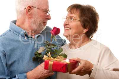 Happy Senior Couple with Gift and Red Rose