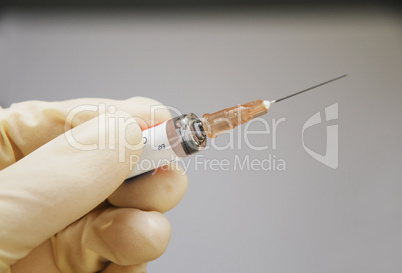 syringe and hand