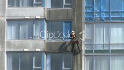 Worker Washing New High Rise Apt Building