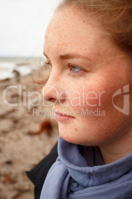 Young caucasian woman looking out to sea