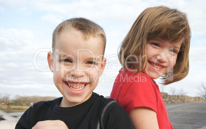 Two Children Smile for the Camera