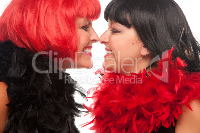 Red and Black Haired Women Smiling at Each Other