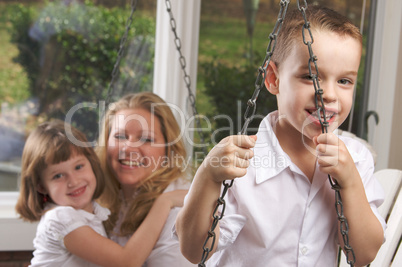 Young Boy Poses with Mom and Sister