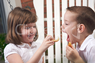 Sister and Brother Eating an Apple