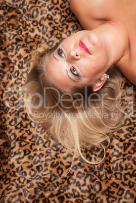 Beautiful Blonde Woman Poses on Leopard Blanket.