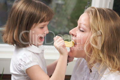 Daughter Feeding Mom an Apple