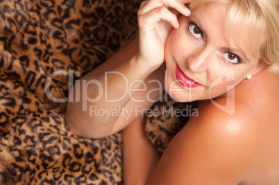 Beautiful Blonde Woman Poses on Leopard Blanket.