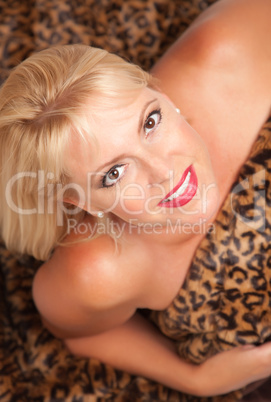 Beautiful Blonde Woman Poses on Leopard Blanket.