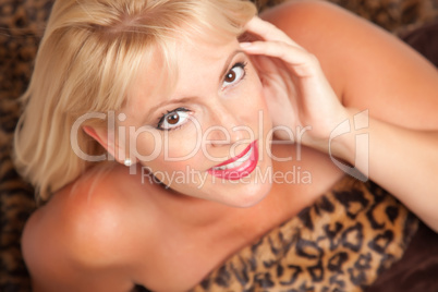 Beautiful Blonde Woman Poses on Leopard Blanket.