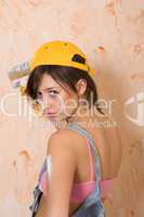 young girl painting wall