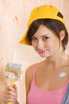 young girl painting wall