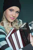 beautiful blonde in sweater with books
