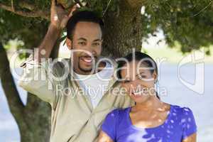 Happy Romantic African American Couple Smiling Under A Tree